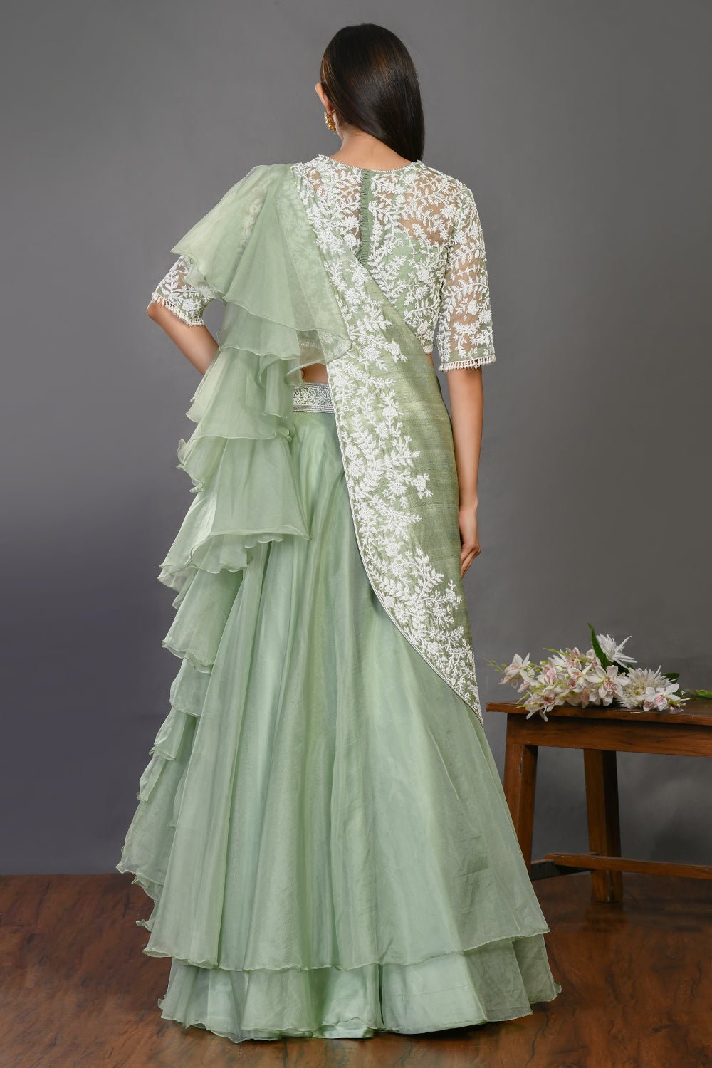 Shop stunning mint green embroidered designer lehenga online in USA with dupatta. Dazzle on weddings and special occasions with exquisite Indian designer dresses, sharara suits, Anarkali suits, wedding lehengas from Pure Elegance Indian fashion store in USA.-back