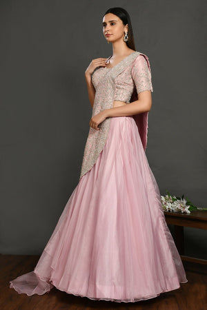Buy beautiful pastel pink embroidered designer lehenga online in USA with dupatta. Dazzle on weddings and special occasions with exquisite Indian designer dresses, sharara suits, Anarkali suits, wedding lehengas from Pure Elegance Indian fashion store in USA.-left