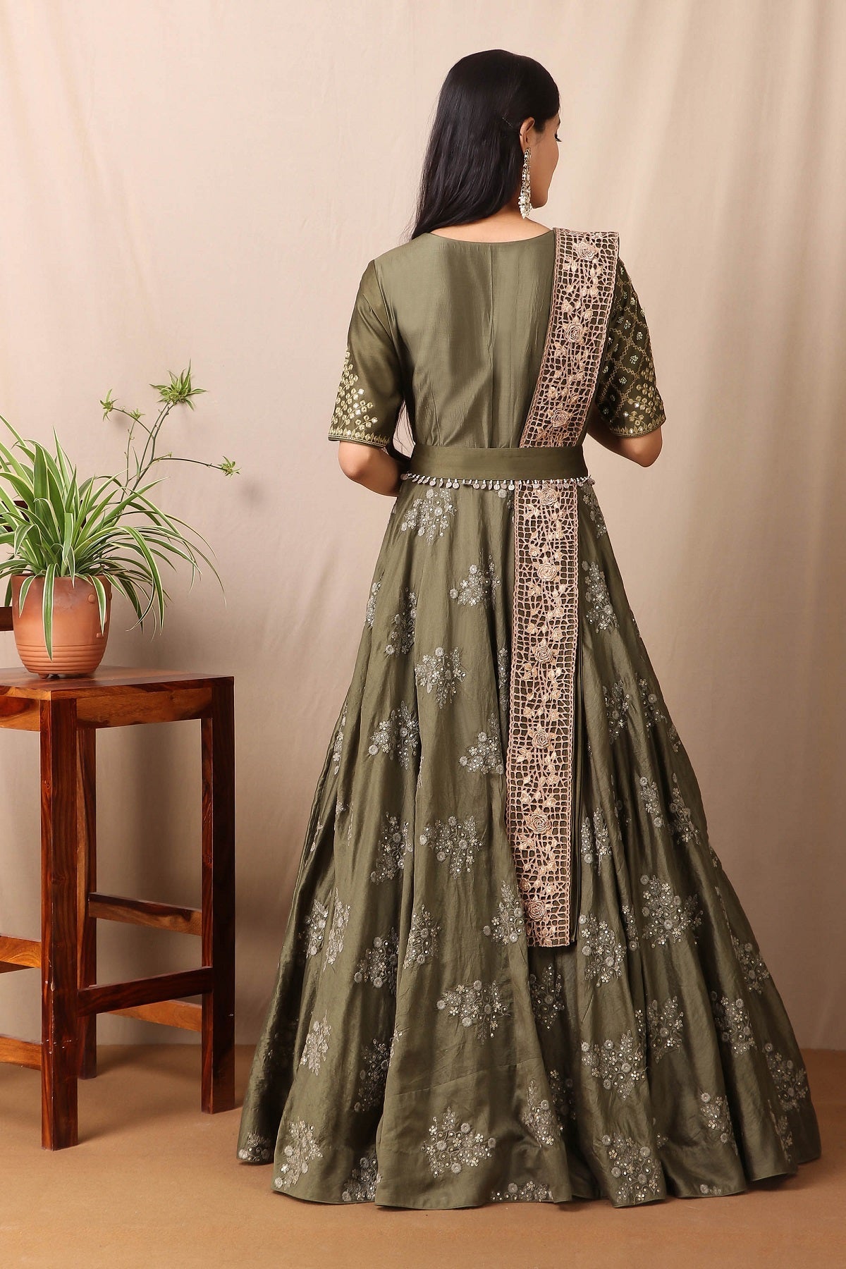 Shop this beautiful kai green embroidered anarkali set with mirror work from Pure Elegance featuring intricate embroidery and a V-neck. Made with premium quality chanderi silk fabric, this set contains a anarkali suit, a dupatta with zari work, and a belt. Pair it up with statement jewellery to complete your look from Pure Elegance Indian clothing store in USA online now.-Back view.