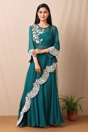 Shop beautiful set of tabby silk green cape style kurta and sharara with thread and pearl work in floral pattern from Pure Elegance. Complete the look by wearing statement jewellery and heels. Light up your ethnic collection of clothing with this kurta sharara set from Pure elegance. It's woven from a fabric that's airy and uber soft against your skin  Pair it up with statement jewellery to complete your look from Pure Elegance Indian clothing store in USA online now.-Full view.