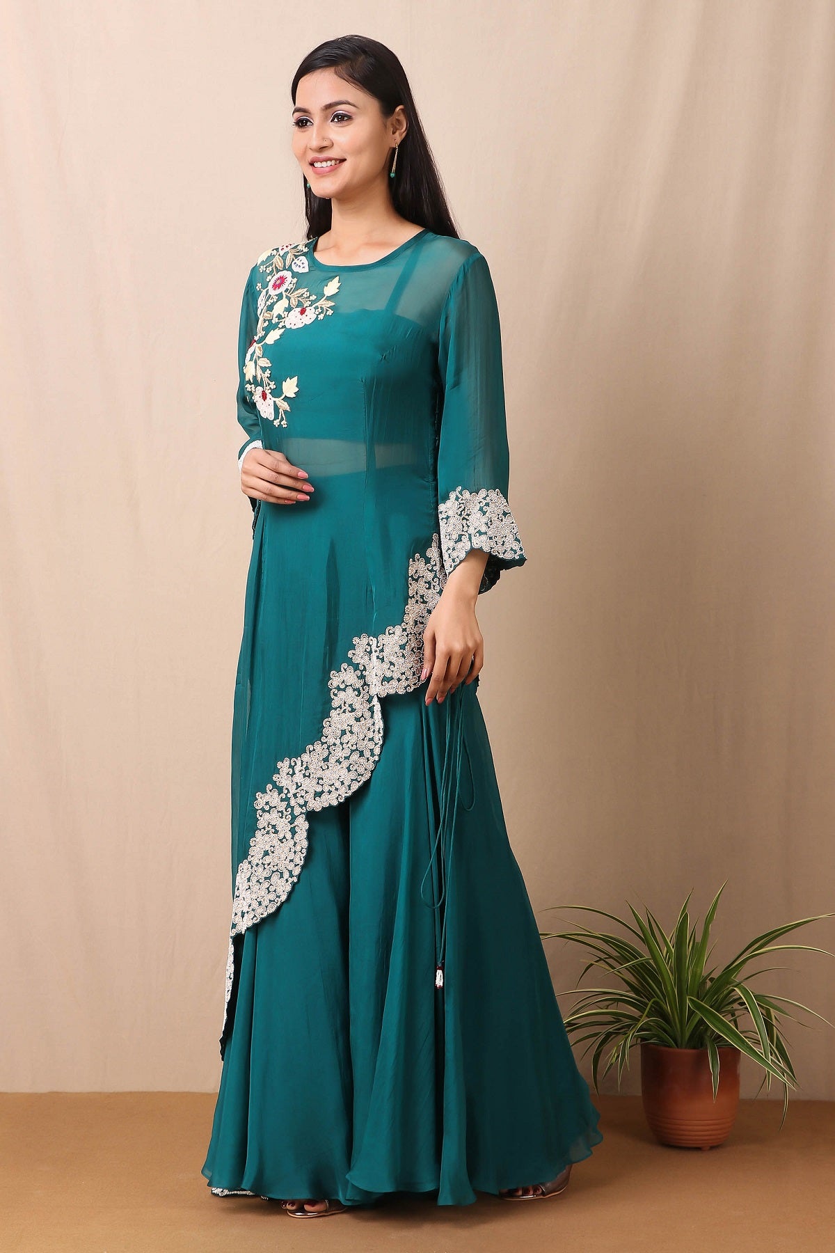 Shop beautiful set of tabby silk green cape style kurta and sharara with thread and pearl work in floral pattern from Pure Elegance. Complete the look by wearing statement jewellery and heels. Light up your ethnic collection of clothing with this kurta sharara set from Pure elegance. It's woven from a fabric that's airy and uber soft against your skin  Pair it up with statement jewellery to complete your look from Pure Elegance Indian clothing store in USA online now.-Side view.