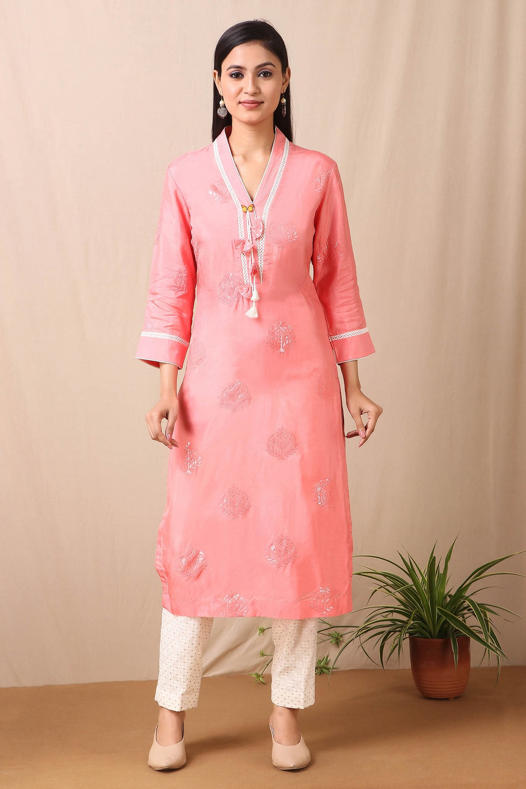 Shop beautiful set of Carrot Peach Upadda Silk Kurta with Tonal Sequins Motifs and lace around the neckline with beautiful tassels on it and cotton stretch white pant from Pure Elegance. Complete the look by wearing statement jewellery and heels. Light up your ethnic collection of clothing with this kurta cotton white pant set from Pure elegance.  Pair it up with statement jewellery to complete your look from Pure Elegance Indian clothing store in USA online now.-Full view.