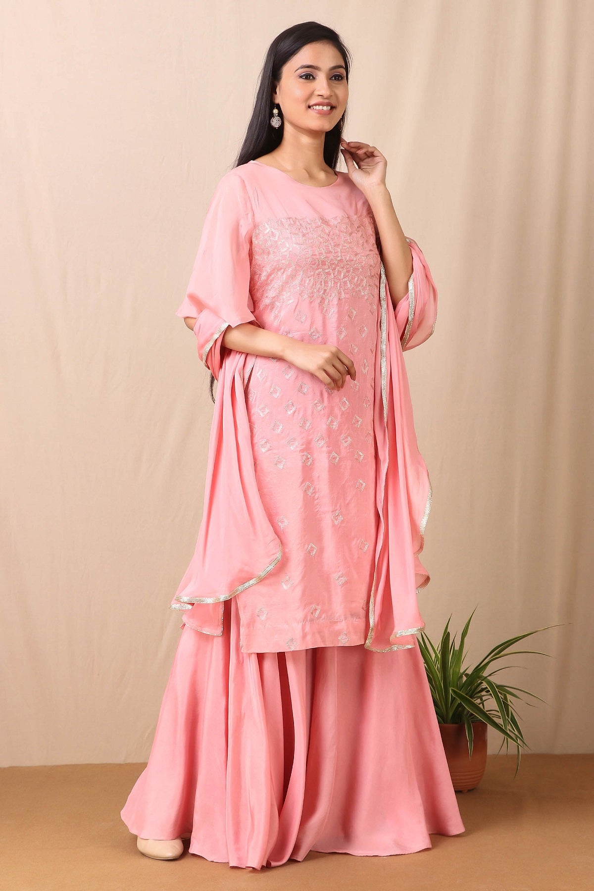Shop beautiful set of set of Pink Upadda Silk with Satin Organza Sharara and Tabby Dupatta and Tonal Sequins Motifs, lace around the neckline with beautiful tassels on it from Pure Elegance. Light up your ethnic collection of clothing with this kurta and sharara from Pure elegance. It's woven from a fabric that's airy and uber soft against your skin. Pair it up with statement jewellery to complete your look from Pure Elegance Indian clothing store in USA online now.-Side view.