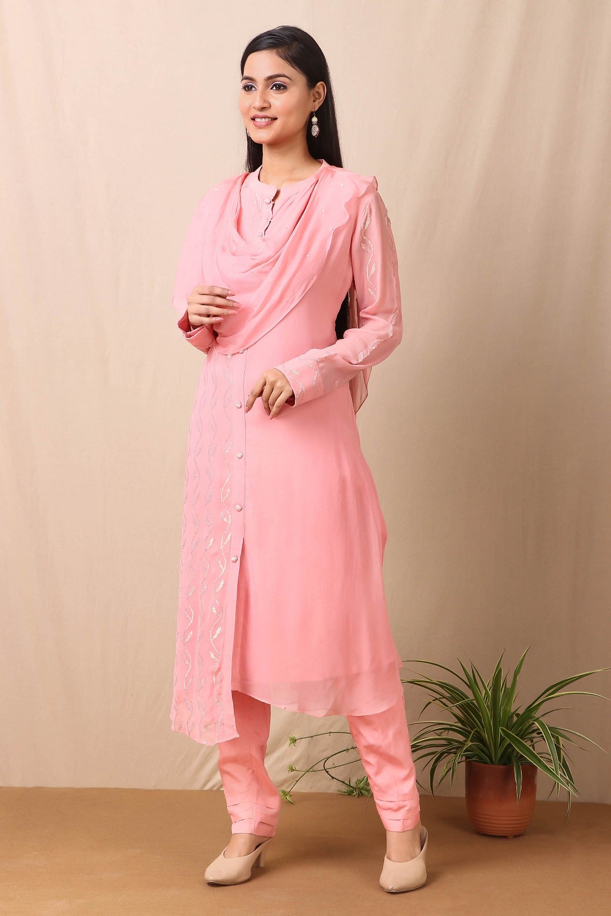 Shop beautiful set of set of  pink georgette embroidered kurta with cotton stretch pants and tabby scarf from Pure Elegance. Complete the look by wearing statement jewellery and heels. Light up your ethnic collection of clothing with this kurta and embelished with light rose gold sequin embroidery. It's woven from a fabric that's airy and uber soft against your skin. Pair it up with statement jewellery to complete your look from Pure Elegance Indian clothing store in USA online now.-Side view.