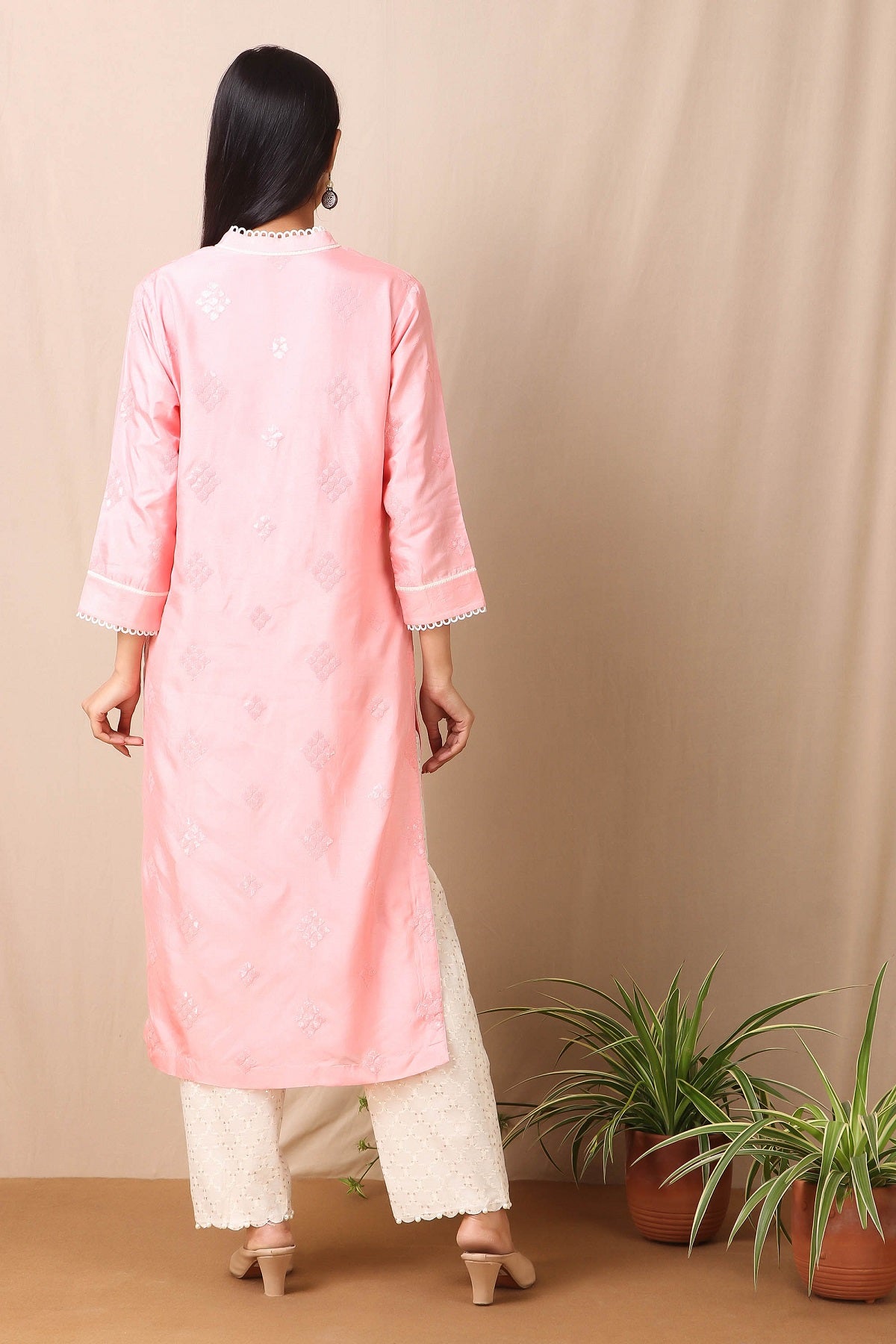 Shop beautiful set of pink upadda silk kurta with tonal sequins motifs and lace around the neckline with beautiful tassels on it and cotton stretch white pant from Pure Elegance. Complete the look by wearing statement jewellery and heels. Light up your ethnic collection of clothing with this kurta cotton white pant set from Pure elegance.  Pair it up with statement jewellery to complete your look from Pure Elegance Indian clothing store in USA online now.-Back view.