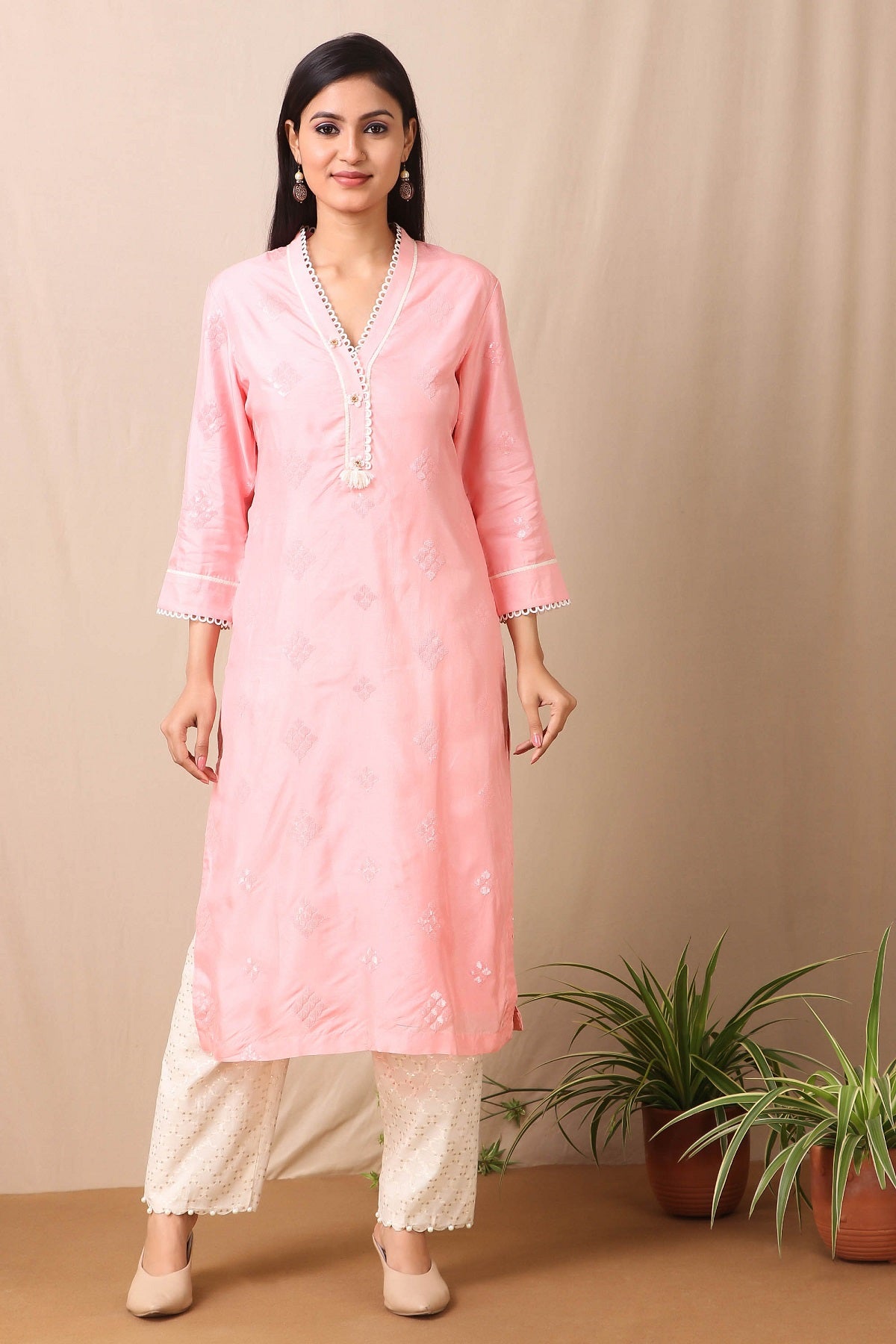 Shop beautiful set of pink upadda silk kurta with tonal sequins motifs and lace around the neckline with beautiful tassels on it and cotton stretch white pant from Pure Elegance. Complete the look by wearing statement jewellery and heels. Light up your ethnic collection of clothing with this kurta cotton white pant set from Pure elegance.  Pair it up with statement jewellery to complete your look from Pure Elegance Indian clothing store in USA online now.-Full view.