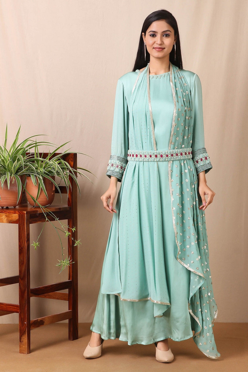 Shop this gorgeous bamberg satin embroidered dress in teel blue color with georgette dupatta featuring a beautiful neckline , belt and cuffs with cutdana and ruby, emerald colored stones, thread embroidery work and dupatta. This beautiful satin material outfit showcases beautiful sleeves with sequin embroidery work and stone work on it and dupatta. Style this set with a pair of diamond earrings and solid pumps to finish the look from Pure Elegance Indian clothing store in USA online now.-Full view.