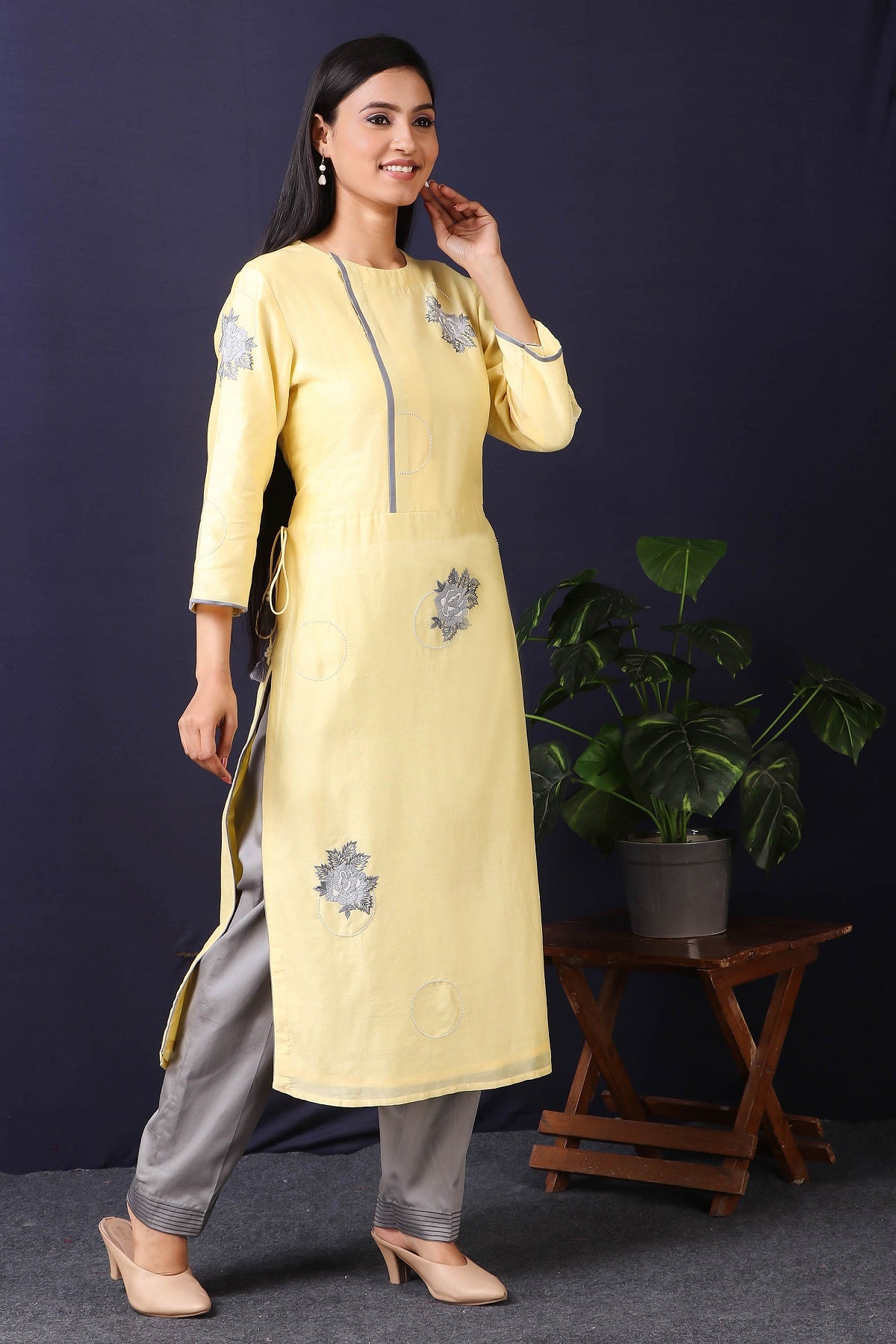 Shop this this gorgeous lemon yellow-grey chanderi kurta set with cotton stretch pant in rose motifs in grey color, a beautiful neckline. This beautiful chanderi silk material outfit showcases beautiful sleeves with rose motifs work offering a comfortable fit. Style this set of kurta and pant with a pair of diamond earrings and solid pumps to finish the look from Pure Elegance Indian clothing store in USA online now.-Side view.