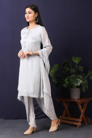 Shop this gorgeous grey pakistani satin organza kurta with crape dhoti and stole set with mirror work with lace edging on sleeves, a beautiful neckline. This beautiful satin organza material outfit showcases beautiful sleeves with lace work on it. Style this set of kurta with dhoti and stole with a pair of diamond earrings and solid pumps to finish the look from Pure Elegance.-Side view.