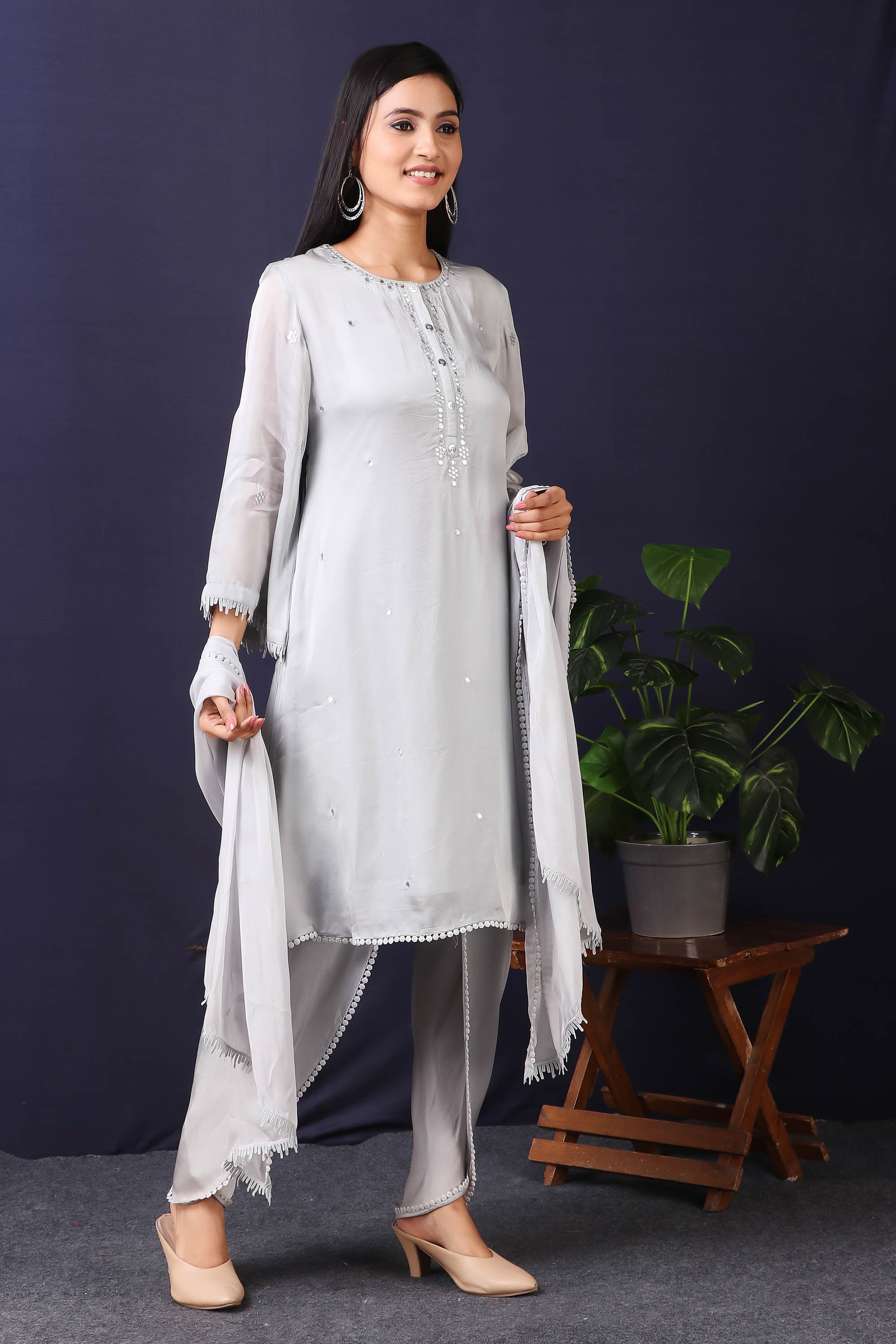 Shop this gorgeous grey pakistani satin organza kurta with crape dhoti and stole set with mirror work with lace edging on sleeves, a beautiful neckline. This beautiful satin organza material outfit showcases beautiful sleeves with lace work on it. Style this set of kurta with dhoti and stole with a pair of diamond earrings and solid pumps to finish the look from Pure Elegance.-Side view.