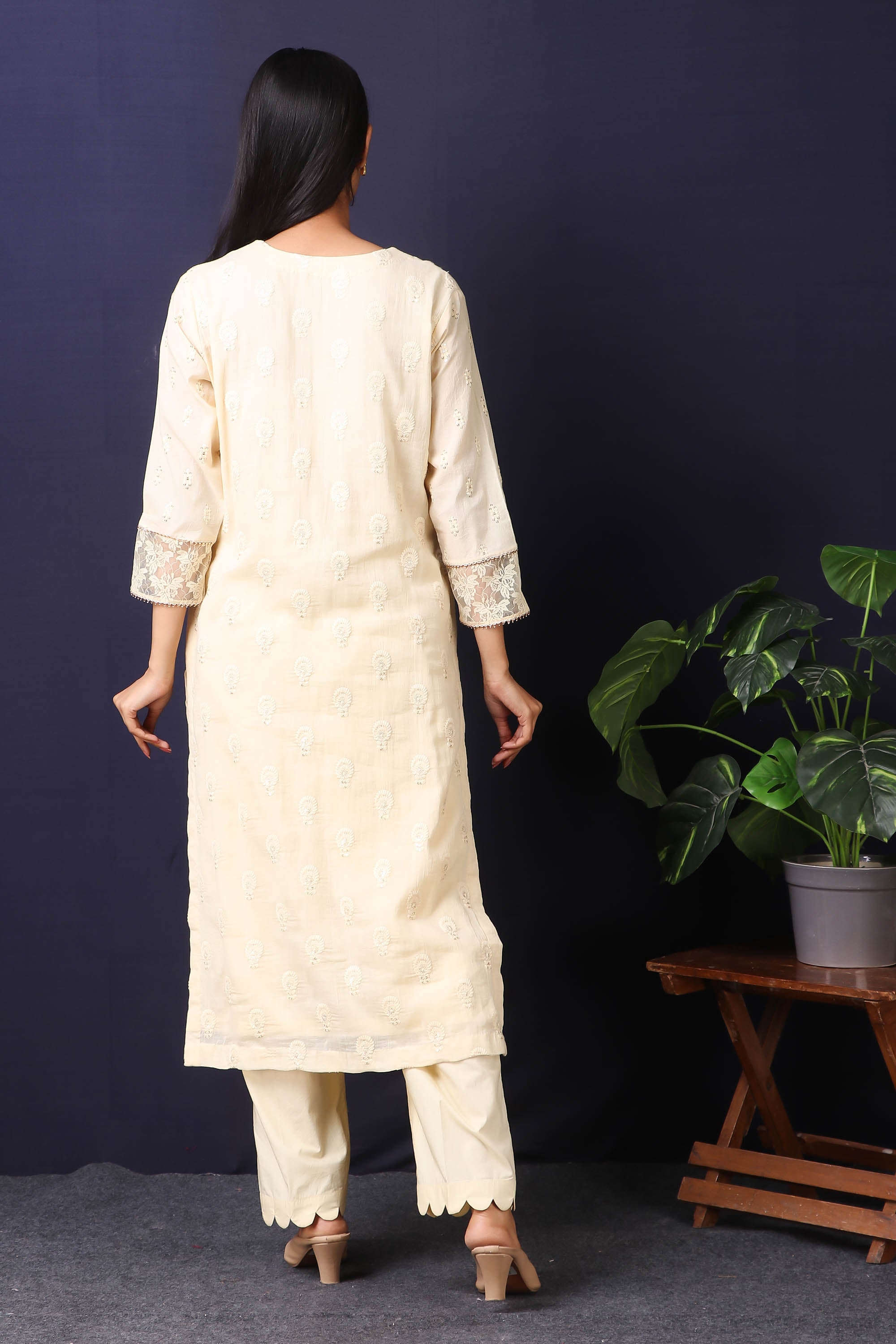 Shop this this gorgeous  mulmul cotton kurta in cream color with cotton stretch pants with sequin and thread embroidery work with gota detailing on neckline. This beautiful mulmul cotton material outfit showcases beautiful sleeves with lace work on it. Style this set of kurta with a pair of diamond earrings and solid pumps to finish the look from Pure Elegance Indian fashion store in USA online now.-Back view.