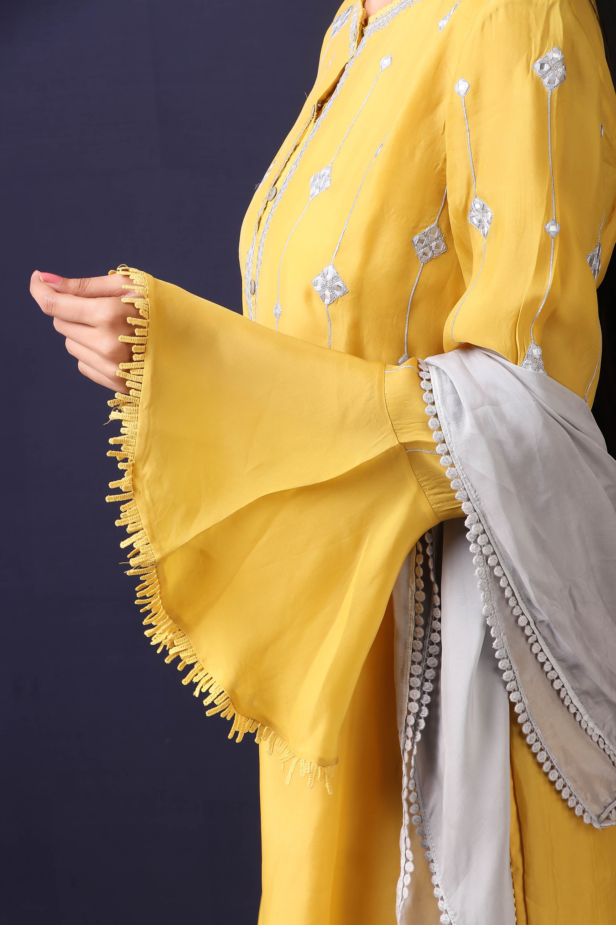 Shop this mustard-grey satin organza pakistani kurta with crepe pant and stole with mirror work with lace edging all over. This beautiful satin organza material outfit showcases beautiful sleeves with lace work on it. Style this set of kurta with a pair of diamond earrings and solid pumps to finish the look from Pure Elegance Indian fashion store in USA online now.-Sleeve view.