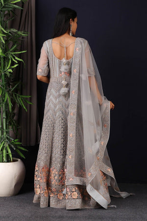 Shop this gorgeous this designer grey embroidered net anarkali with skirt with lace work on it. A fully embroidery work on anarkali suit with heacy dupatta makes this a sophisticated piece of luxury that will captivate you in its calmness and serenity. Style this set with a pair of diamond earrings and solid pumps to finish the look from Pure Elegance Indian fashion store in USA online now.-Back view.
