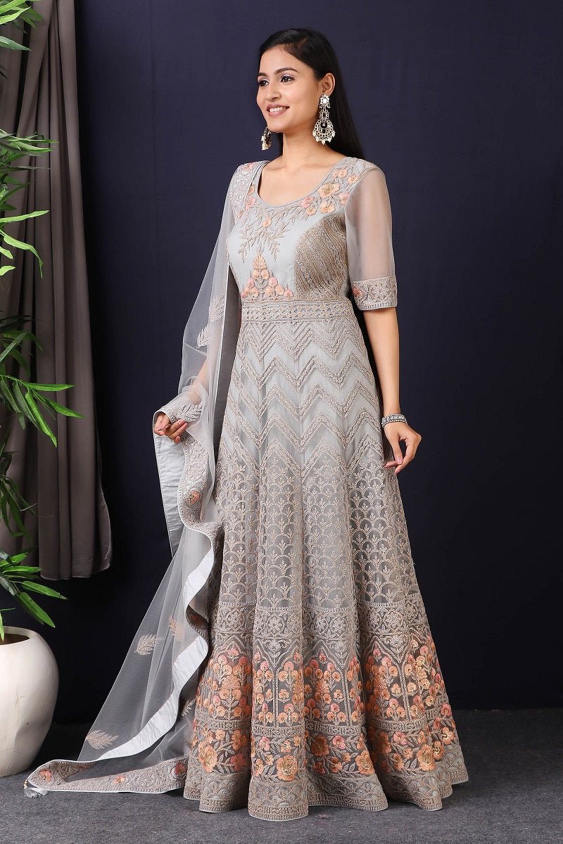Shop this gorgeous this designer grey embroidered net anarkali with skirt with lace work on it. A fully embroidery work on anarkali suit with heacy dupatta makes this a sophisticated piece of luxury that will captivate you in its calmness and serenity. Style this set with a pair of diamond earrings and solid pumps to finish the look from Pure Elegance Indian fashion store in USA online now.-Side view.