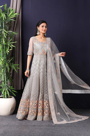 Shop this gorgeous this designer grey embroidered net anarkali with skirt with lace work on it. A fully embroidery work on anarkali suit with heacy dupatta makes this a sophisticated piece of luxury that will captivate you in its calmness and serenity. Style this set with a pair of diamond earrings and solid pumps to finish the look from Pure Elegance Indian fashion store in USA online now.-Side view with open dupatta.