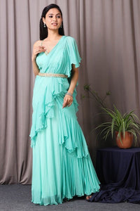 Shop this designer indo western Saree in aqua blue colour. This saree comes in chiffon and upadda silk fabric. The borders of the saree have an exquisite design that is eye-catchy and has sequin and thread embroidery work on it. Complete the look with embroidered blouse showcasing floral and animal motifs especially around the neckline and on the backside. Shop this designer from Pure Elegance Online Indian store now.-Front view.
