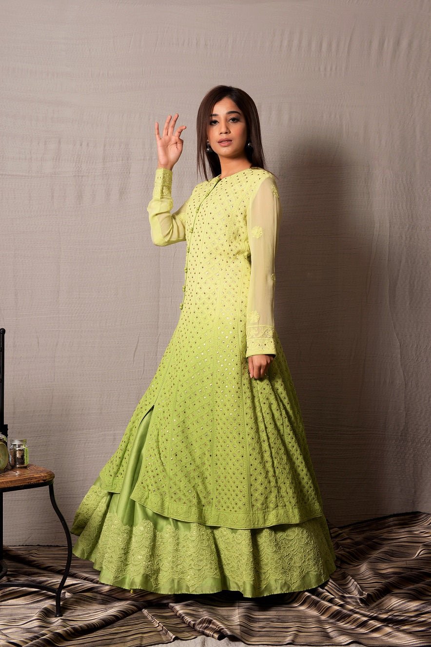 Shop this designer designer light green long georgette and silk chanderi anarkali with skirt with lace work on it. This asymmetrical layered piece in light green shade is embellished with hand lucknowi work and mukaish highlight. Style this fully mirror work on anarkali suit set with a pair of diamond earrings and solid pumps to finish the look from Pure Elegance. Indian clothing store in USA online now.-Side view.