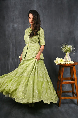 Buy this pista green pure silk organza peplum lehenga from Pure Elegance featuring intricate  tonal thread embroidery and slight shimmer work. Made with premium quality pure silk organza fabric, this set contains a choli, a lehenga. Pair it up with statement jewellery to complete your lookbook this season. Style this set with a pair of diamond earrings and solid pumps to finish the look from Pure Elegance  Indian clothing store in USA online now.-Side view.