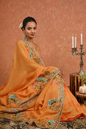 Shop this gorgeous safrron lehenga choli from Pure Elegance featuring intricate embroidery and a V-neck. Made with premium quality georgette and silk fabric, this set contains a choli, a lehenga, and a dupatta. Pair it up with statement jewellery to complete your lookbook this season Style this set with a pair of diamond earrings and solid pumps to finish the look from Pure Elegance Indian clothing store in USA online now.-Sitting posture.