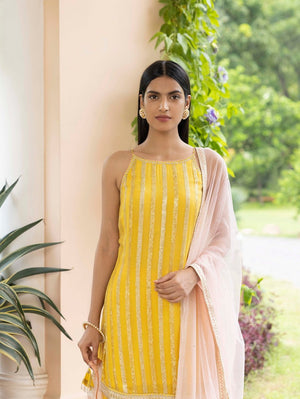 Shop beautiful yellow embroidered sharara suit online in USA with dupatta. Dazzle on weddings and special occasions with exquisite Indian designer dresses, sharara suits, Anarkali suits, wedding lehengas from Pure Elegance Indian fashion store in USA.-front