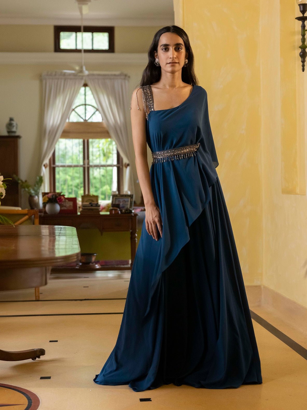 Buy beautiful navy blue asymmetric gown online in USA with embellished belt. Dazzle on weddings and special occasions with exquisite Indian designer dresses, sharara suits, Anarkali suits, wedding lehengas from Pure Elegance Indian fashion store in USA.-front