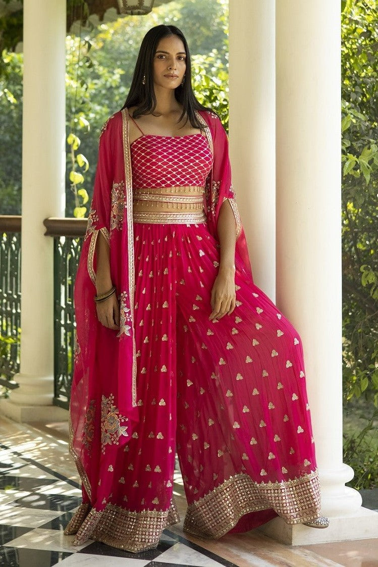 Buy beautiful fuschia pink embroidered palazzo crop top online in USA with cape. Dazzle on weddings and special occasions with exquisite Indian designer dresses, sharara suits, Anarkali suits, wedding lehengas from Pure Elegance Indian fashion store in USA.-full view