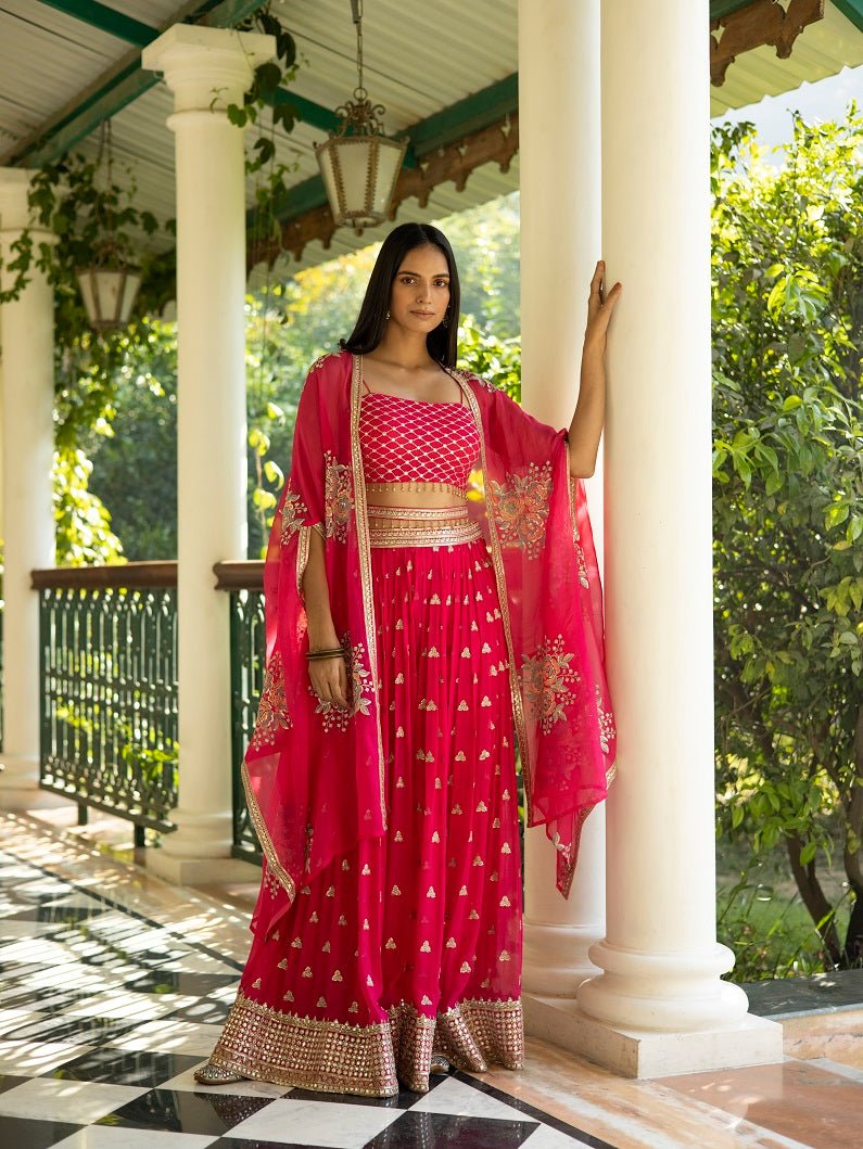 Buy beautiful fuschia pink embroidered palazzo crop top online in USA with cape. Dazzle on weddings and special occasions with exquisite Indian designer dresses, sharara suits, Anarkali suits, wedding lehengas from Pure Elegance Indian fashion store in USA.-palazzo
