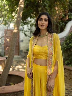 Shop stunning canary yellow palazzo crop top online in USA with multi thread cape. Dazzle on weddings and special occasions with exquisite Indian designer dresses, sharara suits, Anarkali suits, wedding lehengas from Pure Elegance Indian fashion store in USA.-front