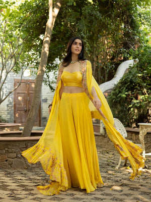 Shop stunning canary yellow palazzo crop top online in USA with multi thread cape. Dazzle on weddings and special occasions with exquisite Indian designer dresses, sharara suits, Anarkali suits, wedding lehengas from Pure Elegance Indian fashion store in USA.-palazzo