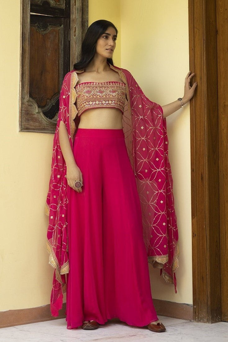 Shop beautiful rani pink embroidered sharara online in USA with bustier and cape. Dazzle on weddings and special occasions with exquisite Indian designer dresses, sharara suits, Anarkali suits, wedding lehengas from Pure Elegance Indian fashion store in USA.-full view