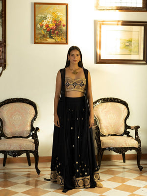 Buy beautiful midnight blue embroidered bustier and sharara online in USA with cape. Dazzle on weddings and special occasions with exquisite Indian designer dresses, sharara suits, Anarkali suits, wedding lehengas from Pure Elegance Indian fashion store in USA.-front