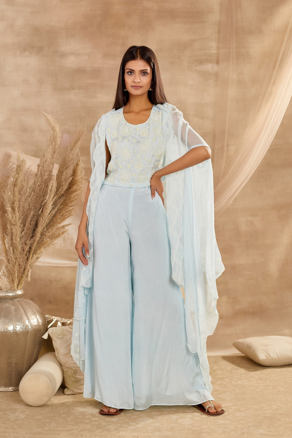 Buy beautiful powder blue embroidered cape sleeves crop top online in USA with trousers. Dazzle on weddings and special occasions with exquisite Indian designer dresses, sharara suits, Anarkali suits, wedding lehengas from Pure Elegance Indian fashion store in USA.-full view