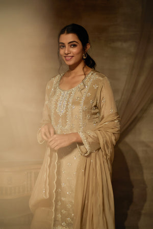 Buy stunning beige embroidered sharara suit online in USA with dupatta. Dazzle on weddings and special occasions with exquisite Indian designer dresses, palazzo suits, Anarkali suits, wedding lehengas from Pure Elegance Indian fashion store in USA.-closeup