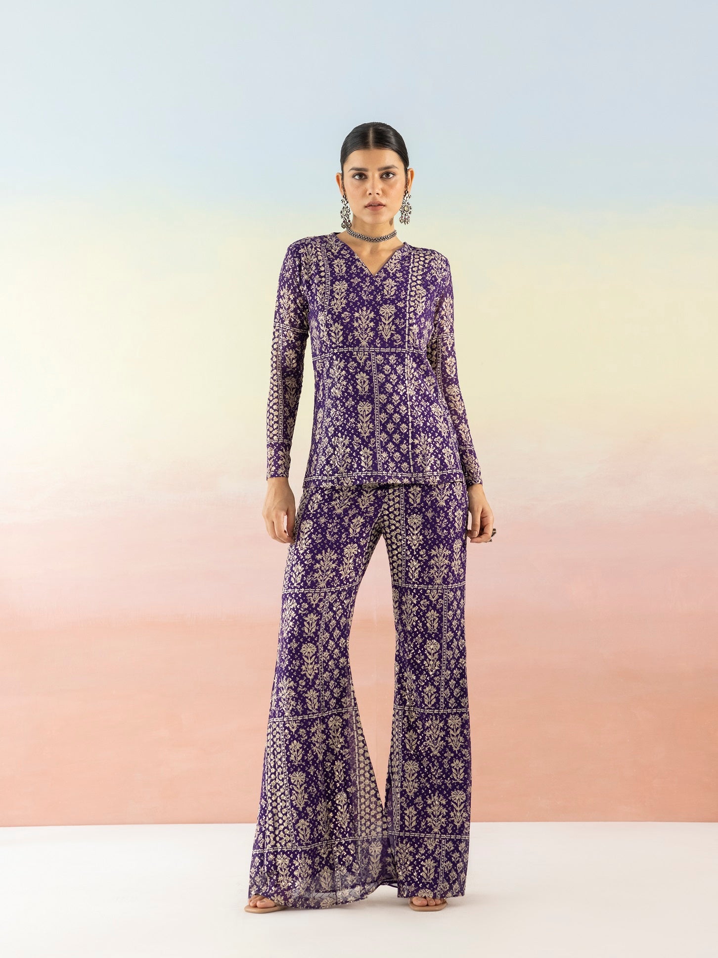 Shop purple embellished V-neck style kurta online in USA with flared pants. Make a fashion statement on festive occasions and weddings with designer suits, Indian dresses, Anarkali suits, palazzo suits, designer gowns, sharara suits from Pure Elegance Indian fashion store in USA.-front