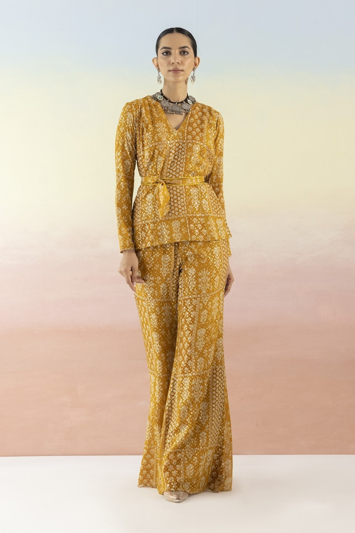 Buy beautiful mustard embellished V-neck style kurta online in USA with flared pants. Make a fashion statement on festive occasions and weddings with designer suits, Indian dresses, Anarkali suits, palazzo suits, designer gowns, sharara suits from Pure Elegance Indian fashion store in USA.-full view