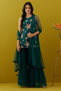 Shop stunning teal embroidered sharara suit online in USA with dupatta. Dazzle on weddings and special occasions with exquisite Indian designer dresses, sharara suits, Anarkali suits, bridal lehengas, sharara suits from Pure Elegance Indian clothing store in USA.-full view