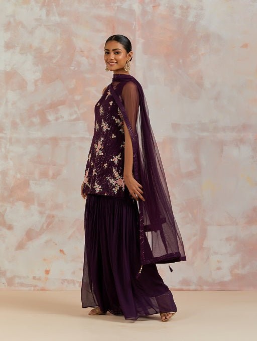 Buy stunning wine embroidered sharara suit online in USA with dupatta. Dazzle on weddings and special occasions with exquisite Indian designer dresses, sharara suits, Anarkali suits, bridal lehengas, sharara suits from Pure Elegance Indian clothing store in USA.-side