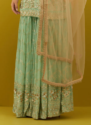 Buy beautiful aqua embroidered sharara suit online in USA with peach dupatta. Dazzle on weddings and special occasions with exquisite Indian designer dresses, sharara suits, Anarkali suits, bridal lehengas, sharara suits from Pure Elegance Indian clothing store in USA.-sharara