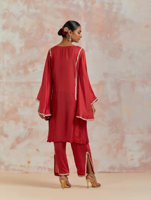 Buy beautiful red muslin suit online in USA with gota work and butterfly sleeves. Dazzle on weddings and special occasions with exquisite Indian designer dresses, sharara suits, Anarkali suits, bridal lehengas, sharara suits from Pure Elegance Indian clothing store in USA.-back