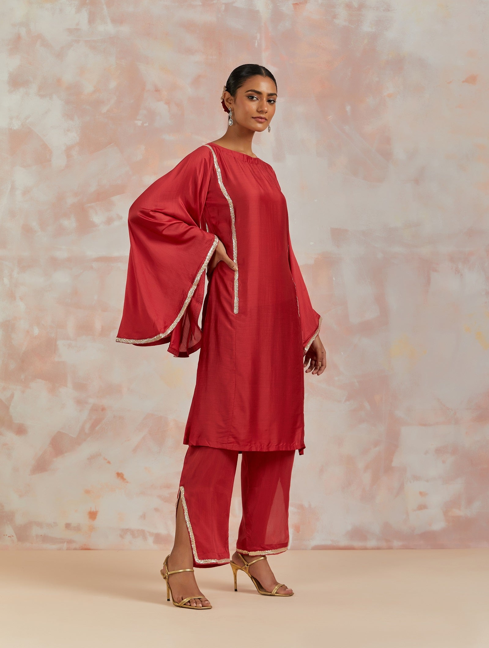Buy beautiful red muslin suit online in USA with gota work and butterfly sleeves. Dazzle on weddings and special occasions with exquisite Indian designer dresses, sharara suits, Anarkali suits, bridal lehengas, sharara suits from Pure Elegance Indian clothing store in USA.-side