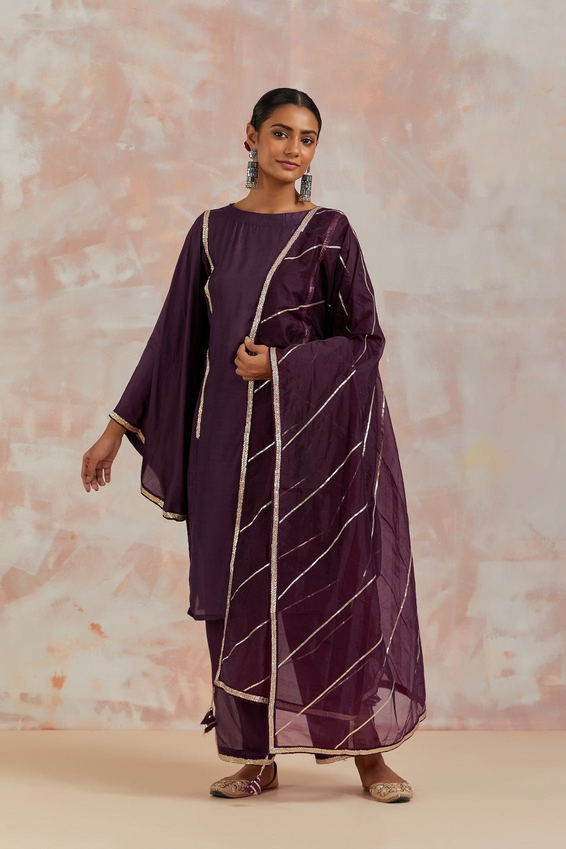 Shop beautiful purple muslin suit online in USA with gota work and butterfly sleeves. Dazzle on weddings and special occasions with exquisite Indian designer dresses, sharara suits, Anarkali suits, bridal lehengas, sharara suits from Pure Elegance Indian clothing store in USA.-full view