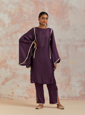 Shop beautiful purple muslin suit online in USA with gota work and butterfly sleeves. Dazzle on weddings and special occasions with exquisite Indian designer dresses, sharara suits, Anarkali suits, bridal lehengas, sharara suits from Pure Elegance Indian clothing store in USA.-front