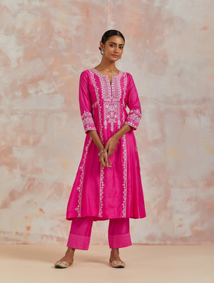 Shop beautiful rani pink chanderi cotton suit online in USA with pants and dupatta. Dazzle on weddings and special occasions with exquisite Indian designer dresses, sharara suits, Anarkali suits, bridal lehengas, sharara suits from Pure Elegance Indian clothing store in USA.-front