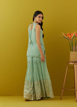Buy beautiful aqua green embroidered sharara suit online in USA with peach dupatta. Dazzle on weddings and special occasions with exquisite Indian designer dresses, sharara suits, Anarkali suits, bridal lehengas, sharara suits from Pure Elegance Indian clothing store in USA.-back