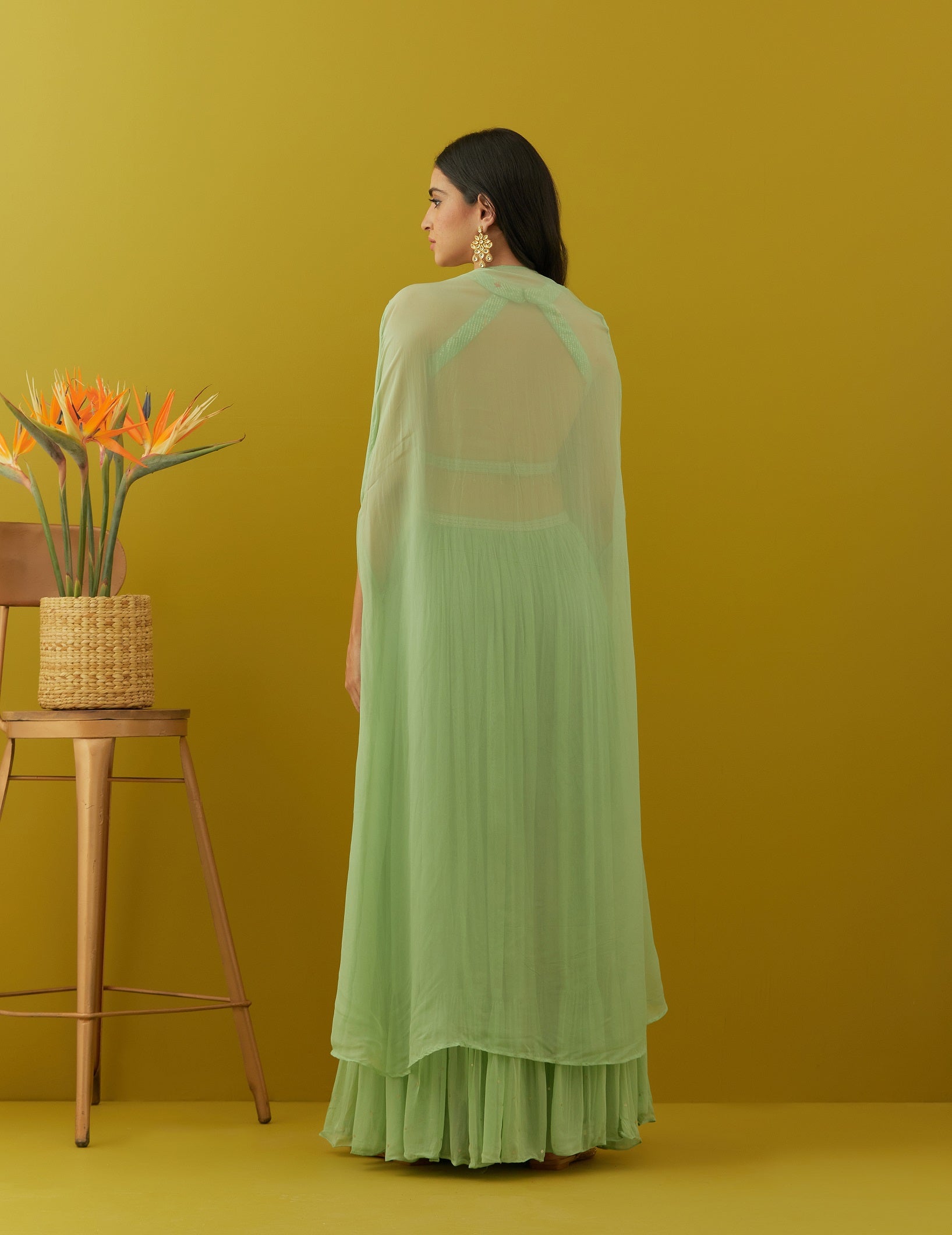 Shop green embroidered bustier online in USA with sharara and cape. Dazzle on weddings and special occasions with exquisite Indian designer dresses, sharara suits, Anarkali suits, bridal lehengas, sharara suits from Pure Elegance Indian clothing store in USA.-back