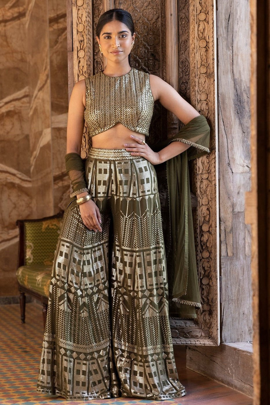 Buy stunning olive green sequin sharara suit online in USA with net dupatta. Dazzle on weddings and special occasions with exquisite Indian designer dresses, sharara suits, Anarkali suits, bridal lehengas, sharara suits from Pure Elegance Indian clothing store in USA.-full view