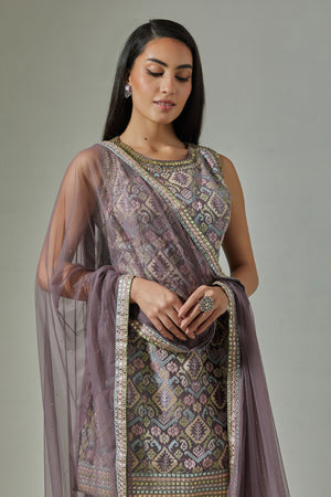 Buy stunning lilac hand embroidered jacquard sharara suit online in USA with net dupatta. Dazzle on weddings and special occasions with exquisite Indian designer dresses, sharara suits, Anarkali suits, wedding lehengas from Pure Elegance Indian fashion store in USA.-closeup