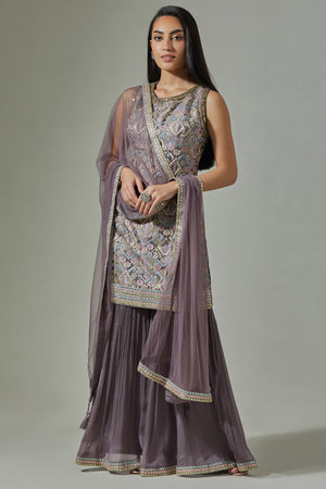 Buy stunning lilac hand embroidered jacquard sharara suit online in USA with net dupatta. Dazzle on weddings and special occasions with exquisite Indian designer dresses, sharara suits, Anarkali suits, wedding lehengas from Pure Elegance Indian fashion store in USA.-suit