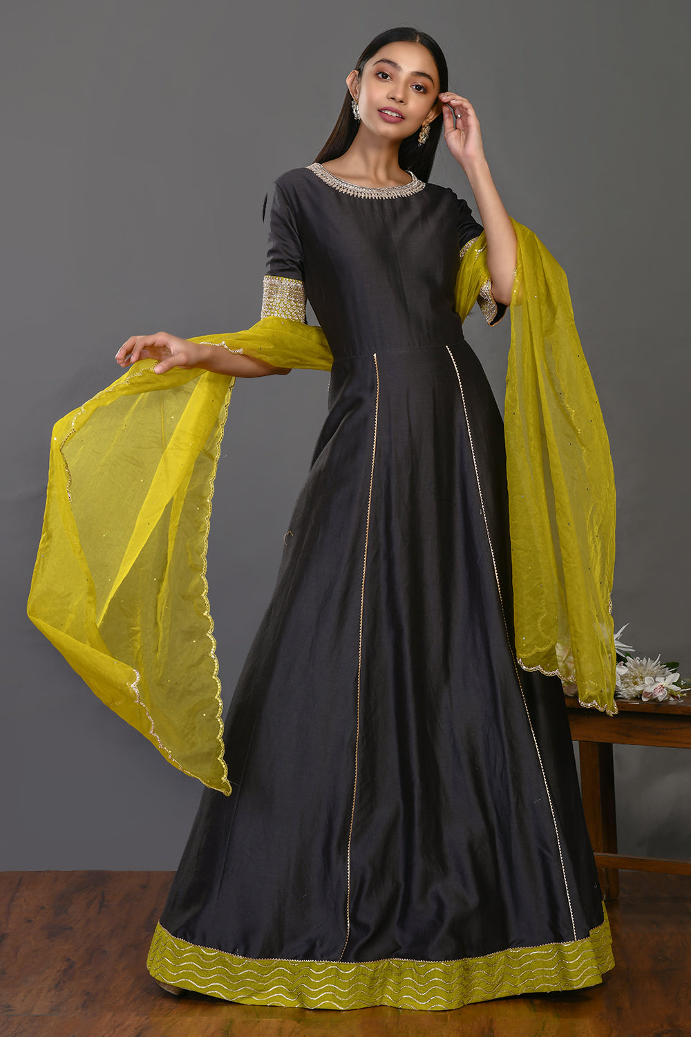 Shop black floorlength chanderi Anarkali online in USA with embroidered yellow dupatta. Dazzle on weddings and special occasions with exquisite Indian designer dresses, sharara suits, Anarkali suits, wedding lehengas from Pure Elegance Indian fashion store in USA.-front