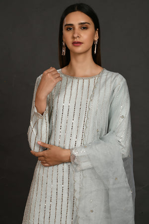 Shop powder blue mirror work silk suit online in USA with pants. Dazzle on weddings and special occasions with exquisite Indian designer dresses, sharara suits, Anarkali suits, wedding lehengas from Pure Elegance Indian fashion store in USA.-closeup